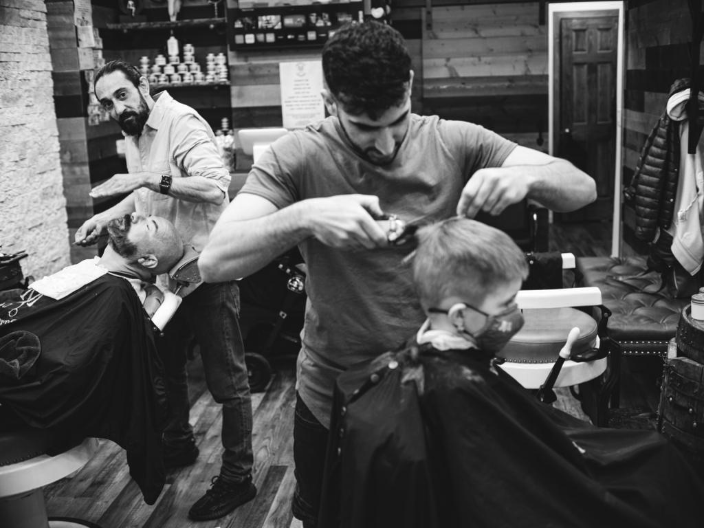 Are there any specific hairstyles that are popular among the LGBTQ+ community at New York barbershops?